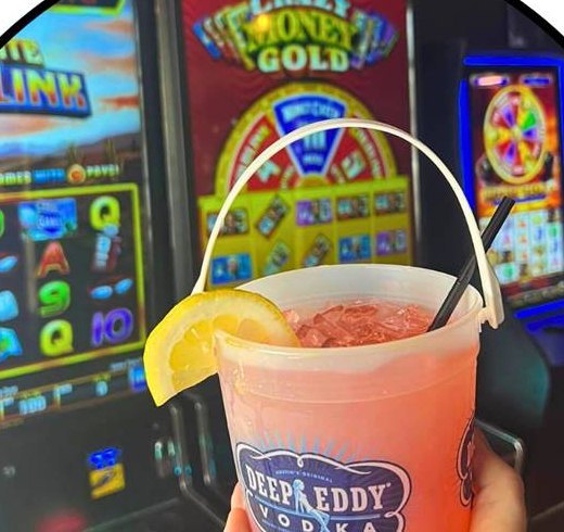 Mason jar cocktail in front of the gaming machines